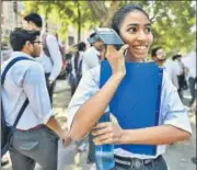  ?? BURHAAN KINU/HT ?? A girl talks on her phone after appearing for the first Class 12 board exam in New Delhi on Monday. >> P2