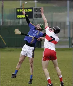  ??  ?? Wicklow’s John Henderson tries to break a ball during the recent NHl Division 2B clash with Derry in Bray.