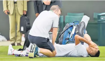  ??  ?? Australia’s Nick Kyrgios reacts as he receives medical attention after sustaining an injury during his first round match against France’s Pierre-Hugues Herbert. — Reuters photo