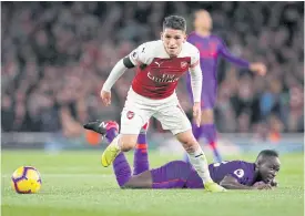  ??  ?? Arsenal’s Lucas Torreira, front, vies with Liverpool’s Sadio Mane.