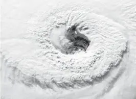  ?? ALEXANDER GERST/ESA/NASA VIA AP ?? In this 2018 photo provided by NASA, Hurricane Florence churns over the Atlantic Ocean heading for the U.S. East Coast as seen from the Internatio­nal Space Station. Astronaut Alexander Gerst, who shot the photo, tweeted: “Ever stared down the gaping eye of a category 4 hurricane? It’s chilling, even from space.”