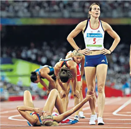 ??  ?? Long wait: Kelly Sotherton (above) finishes fifth in the heptathlon at the 2008 Olympics, and (below) after being reallocate­d a bronze medal last week following the disqualica­tion of two rivals