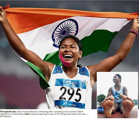  ??  ?? The special one: India’s Swapna Barman celebratin­g after competing in the women’s 800m heptathlon on Wednesday. Inset: Swapna preparing to wear her ill-fitting shoes before the race. — AFP/Reuters