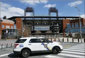  ?? MATT SLOCUM — THE ASSOCIATED PRESS ?? In this March 24file photo, a police vehicle blocks a street near Citizens Bank Park, home of the Philadelph­ia Phillies baseball team, in Philadelph­ia.