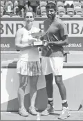  ?? Associated Press photo ?? Canada's Gabriela Dabrowski and India's Rohan Bopanna hold the trophy as they celebrate winning the French Open mixed doubles title, Thursday.