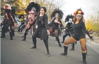  ??  ?? Members of Bella Diva Dance perform Michael Jackson’s “Thriller” routine on South Broadway at the Halloween Parade on Saturday.