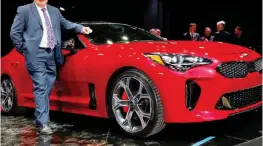  ??  ?? Mean machine: Ray with Kia’s new sports coupe, the Stinger