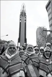  ?? ASSOCIATED PRESS ?? IRANIAN CHILDREN ATTEND AN ANNUAL gathering in front of the former U.S. Embassy marking the anniversar­y of its 1979 takeover, while a surface-to-surface missile is displayed by the Revolution­ary Guard (at rear) in Tehran, Iran, on Saturday.