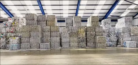  ?? Jeremy Walker / Getty Images ?? Bales of waste paper are seen at a recycling plant.