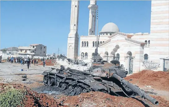  ?? Photo: REUTERS ?? Spoils of war: A burnt-out tank in the northern border province of Aleppo. Syrians have high hopes for a future with Assad, but their dreams may be dashed by postwar reality.