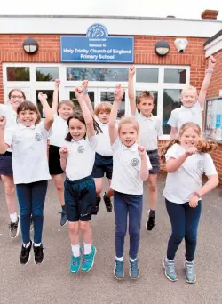  ?? ?? Students at Holy Trinity CofE School, Cookham, celebrate the news that their school has retained its outstandin­g Ofsted rating. Ref: 134515-8