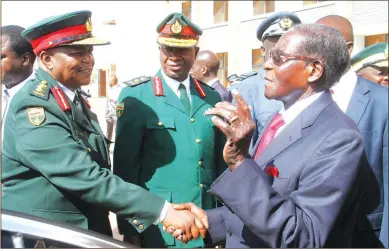  ??  ?? President Mugabe chats with Zimbabwe Defence Forces Commander General Constantin­o Chiwenga, Zimbabwe National Army Commander Lieutenant-General Philip Valerio Sibanda and Air Force of Zimbabwe Commander Air Marshal Perrance Shiri (partly obscured) as...