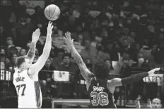  ?? MATT STRASEN/AP ?? DALLAS MAVERICKS GUARD LUKA DONCIC (77) shoots over Boston Celtics guard Marcus Smart (36) during the first half of a game in Dallas on Saturday.