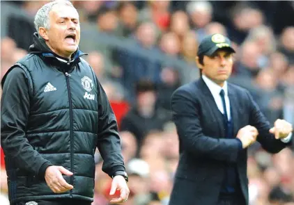  ??  ?? FILE - In this Sunday, April 16, 2017 file photo, Manchester United’s team manager Jose Mourinho, left, and Chelsea’s team manager Antonio Conte react during the English Premier League match between Manchester United and Chelsea at Old Trafford stadium...