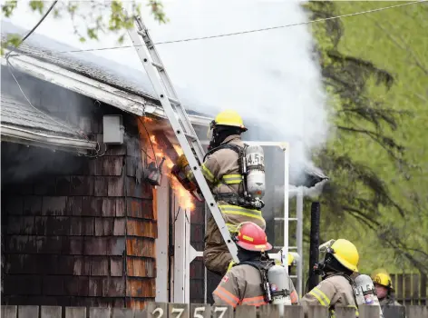  ?? CITIZEN PHOTO BY BRENT BRAATEN ?? Prince George Fire Rescue firefighte­rs battle a blaze at a home in the 2700 block of Houston Lane on Thursday.