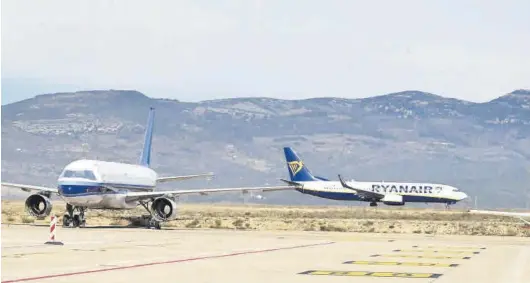  ?? MANOLO NEBOT ?? Dos aviones comerciale­s en el aeropuerto de Castellón, uno de ellos en movimiento, en Vilanova de Alcolea.