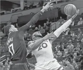  ?? Jim Mone Associated Press ?? TIMBERWOLV­ES GUARD Josh Okogie, right, strains to lift a shot over Clippers defender Garrett Temple during the first half.