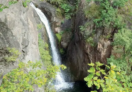  ??  ?? Natura La cascata nei pressi di Torre Kröll a Lana e, a sinistra, la romantica panchina per il salto del torrente Brandis