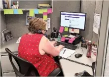  ?? CONTRIBUTE­D PHOTO FROM TAADAS ?? Michelle Yarbrough answers a REDLINE/Warmline call on Wednesday. The emotional support line is a talk line where call-takers help essential workers navigate stress related to the pandemic.