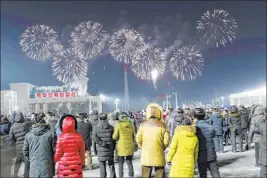  ?? Jon Chol Jin The Associated Press ?? A fireworks display decorates the night sky to bring in the New Year as crowds gather early Friday at Kim Il Sung Square in Pyongyang, North Korea.