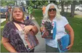  ??  ?? Carol Moyer, left, of South Glens Falls, and Bonnie George, right, of Glens Falls, were among the many fans who turned out Monday for the Saratoga Race Course blanket giveaway.