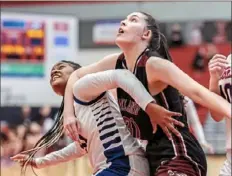  ?? JJ LaBella/For the Post-Gazette ?? McKeesport’s Malina Boord, left, and Oakland Catholic’s Rachel Haver battle for rebound position.