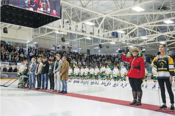  ?? PHOTOS: LIAM RICHARDS ?? Surviving players from the Humboldt Broncos bus crash Brayden Camrud, from left, Derek Patter, Tyler Smith, Jacob Wassermann, Graysen Cameron, Bryce Fiske, Xavier Labelle, Nick Shumlanski, Matthieu Gomercic and Kaleb Dahlgren make an appearance for the national anthem before the Broncos home opener in Humboldt on Wednesday.