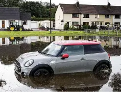  ??  ?? Stuck: A stranded Mini in Lugton, Ayrshire, yesterday