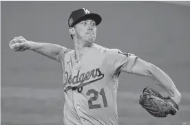  ?? TONY GUTIERREZ/ASSOCIATED PRESS ?? Los Angeles starting pitcher Walker Buehler struck out 10 over six innings to lead the Dodgers to a 6-2 victory Friday night and a 2-1 World Series lead over Tampa Bay.