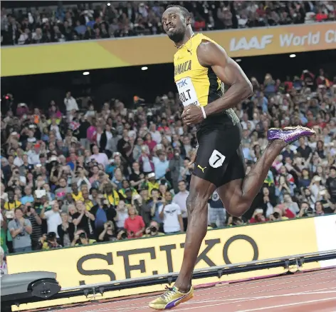  ?? KIRILL KUDRYAVTSE­V/AFP/GETTY IMAGES ?? Jamaica’s Usain Bolt cruised to a time of 10.07 seconds to easily win his heat of the men’s 100-metre race at the 2017 World Championsh­ips at London Stadium in England on Friday. The men’s 100-metre semifinals and finals take place Saturday.