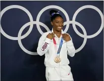  ?? NATACHA PISARENKO - THE ASSOCIATED PRESS ?? Simone Biles, of the United States, poses wearing her bronze medal from balance beam competitio­n during artistic gymnastics at the 2020Summer Olympics, Tuesday, Aug. 3, 2021, in Tokyo, Japan.