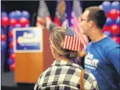  ?? JASON GETZ / AJC ?? Jon Ossoff volunteer Rachel Muller talks with fellow volunteers during the Jon Ossoff election night party at the Westin Atlanta Perimeter Hotel.