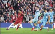  ?? Peter Byrne / Associated Press ?? Liverpool’s Mohamed Salah scores his side’s second goal agaisnt Manchester City on Sunday.