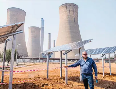  ?? Picture: Gallo Images ?? HARNESSING THE SUN. Komati Power Station manager Marcus Nemadodzi shows off Eskom’s solar power project in Middleburg, where there is also a 1 000MW coal-fired station.