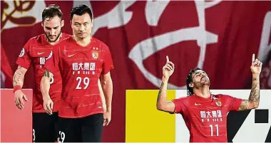  ?? — AFP ?? Shortlived joy: Guangzhou Evergrande’s Ricardo Goulart (right) celebrates after scoring during the AFC Champions League last-16 match against Tianjin Quanjianon Tuesday.