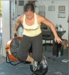  ?? Photo by Steve Sherman ?? Marianne Bomentre does an over-the-bar Burpee as part of a 12-minute exercise routine at CrossFit LBC on Route 13 in Bristol.