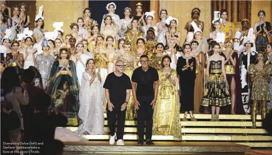  ??  ?? Domenico Dolce (left) and Stefano Gabbana take a bow at the show’s finale.