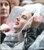  ??  ?? A fan enjoys the line-up from beneath a plastic hoodie in Glasgow Green yesterday.