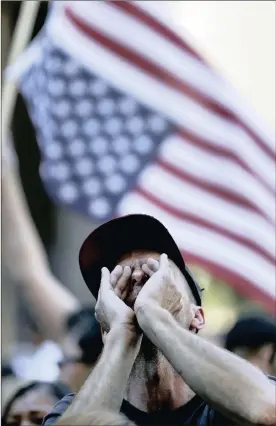  ?? PHOTO: AP ?? People protest outside the Phoenix Convention Center on Tuesday in Phoenix. The dollar wobbled against the yen after Trump’s remarks over a government shut-down at the rally held there.