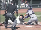  ?? JED JACOBSOHN — THE ASSOCIATED PRESS ?? The Giants’ Wilmer Flores is tagged out at home by the Rockies’ TonyWolter­s on Thursday in San Francisco.