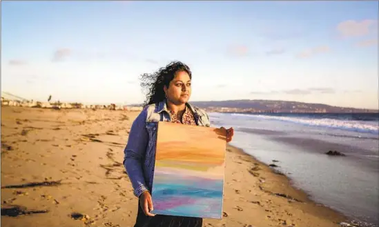  ?? Photograph­s by Allen J. Schaben Los Angeles Times ?? SANDHYA KAMBHAMPAT­I used to keep a spreadshee­t of her long COVID symptoms. Now, painting at the Strand at Hermosa Beach conjures “a feeling of normality and calmness,” she says.