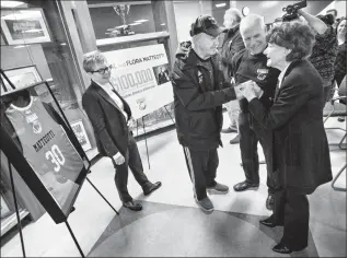  ?? Herald photo by Ian Martens @IMartensHe­rald ?? Lethbridge College president Paula Burns watches as 1994 national champion Kodiak women’s soccer coaches Alvin Tietz and Knud Petersen greet Flora Matteotti after the announceme­nt of a $100,000 gift to support Kodiaks recruitmen­t, awards and scholarshi­ps.