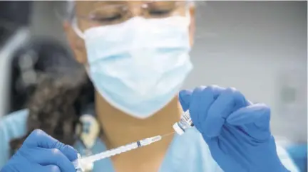  ?? (Photo: AP) ?? In this Thursday, February 11, 2021 file photo, pharmacy technician Sochi Evans fills a syringe with a Pfizer-biontech COVID-19 vaccine at Texas Southern University in Houston.