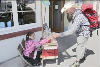  ?? TIMES-STANDARD FILE PHOTO ?? Rowan Dick sells a cup of strawberry lemonade to Topher Reynolds of Eureka during a past Lemonade Day event.