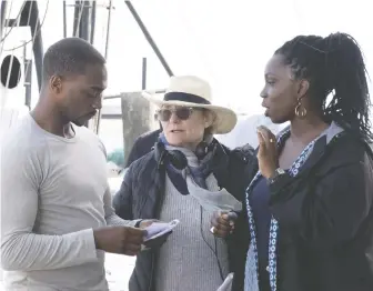  ?? CHUCK ZLOTNICK/DISNEY+ ?? The Falcon and the Winter Soldier director Kari Skogland, centre, seen with stars Anthony Mackie and Adepero Oduye, says she was aware of the gravitas of Falcon being asked to take over the role of Captain America at the end of 2019's Avengers: Endgame when she was making Marvel's new TV series.