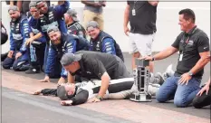  ?? Stacy Revere / Getty Images ?? AJ Allmending­er, center, Matt Kaulig, owner of Kaulig Racing, and the crew celebrate on the yard of bricks after winning the NASCAR Cup Series Verizon 200 at the Brickyard at Indianapol­is Motor Speedway on Sunday.