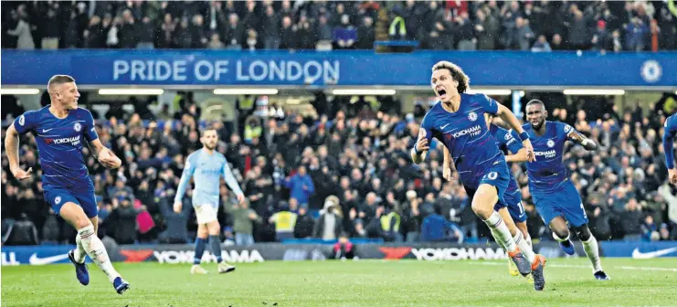  ??  ?? Winning run: David Luiz races to his Chelsea team-mates after scoring