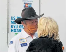  ?? AUSTIN FLESKES / Loveland Weekly ?? Warren Greeno talks with his wife, Beth, outside of a Walmart transporta­tion truck at the Walmart Distributi­on Center Wednesday as Greeno’s family, attended his celebratio­n.