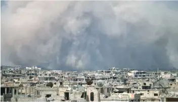  ?? — AFP ?? Smoke billows following a reported air strike on a rebel-held area in the southern Syrian city of Daraa on Tuesday.