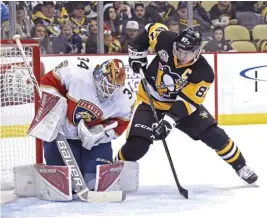  ??  ?? GOALMOUTH ACTION: Florida Panthers goalie James Reimer (34) makes a save as Pittsburgh Penguins center Sidney Crosby (87) waits for a rebound during the second period of an NHL hockey game on Tuesday in Pittsburgh. (AP)